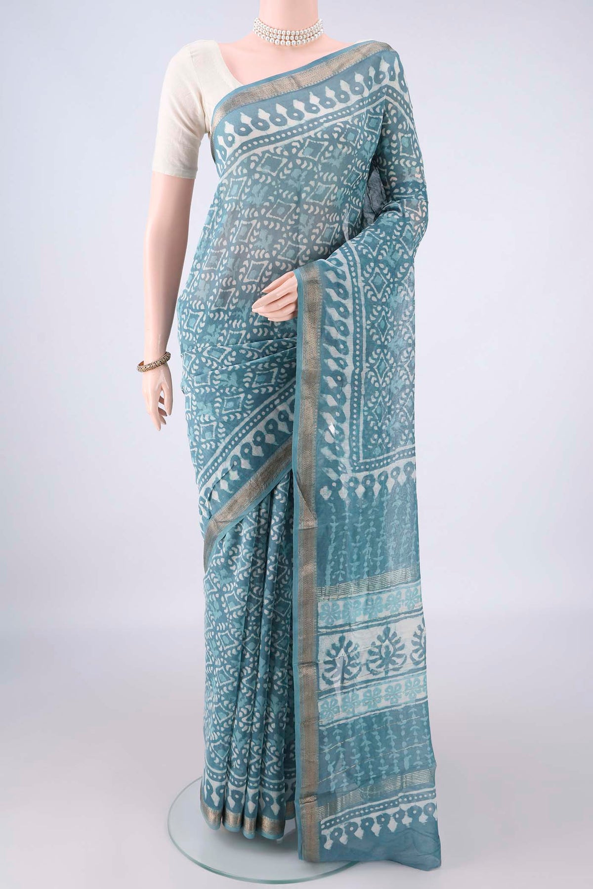 Maya Blue Chanderi Cotton Saree with Batik Print on the body and Zari Border.  displayed on a mannequin
