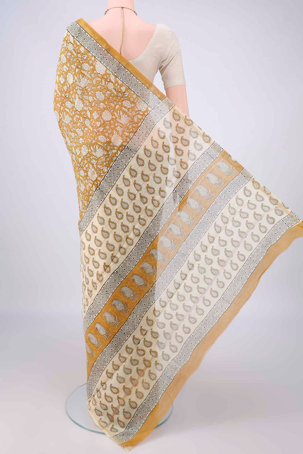 Flat view of Mustard Chanderi Cotton Saree with Batik Print on the body and Thin Zari Line. 