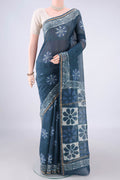 Indigo Chanderi Cotton Saree with Batik Print on the body and Thin Zari Line.  displayed on a mannequin