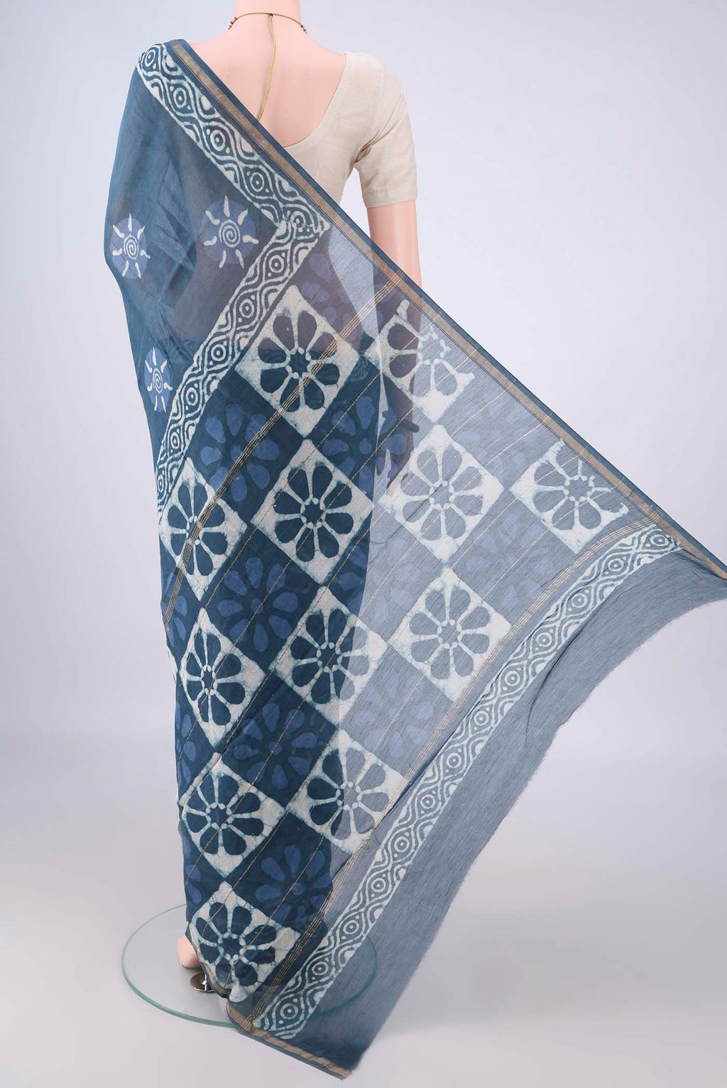 Flat view of Indigo Chanderi Cotton Saree with Batik Print on the body and Thin Zari Line. 