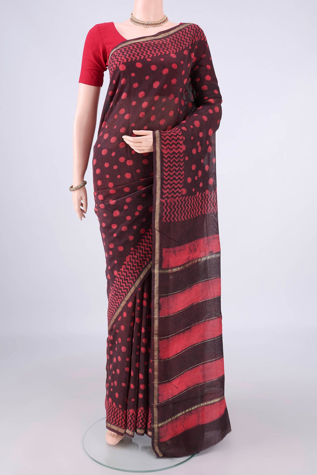 Brown Chanderi Cotton Saree with Batik Print on the body and Thin Zari Line.  displayed on a mannequin