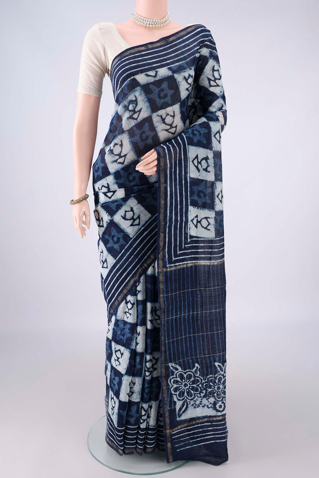 Navy Blue Chanderi Cotton Saree with Batik Print on the body and Thin Zari Line.  displayed on a mannequin