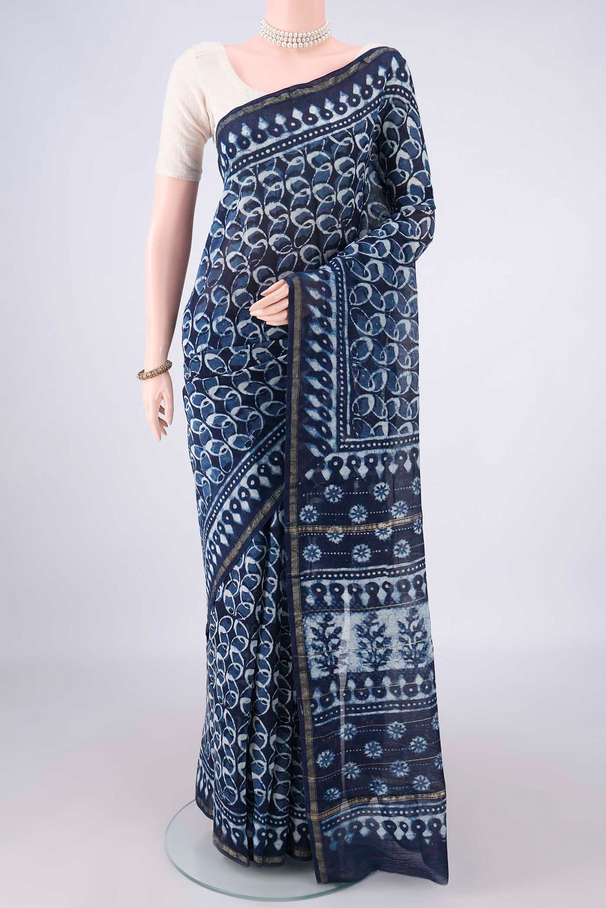 Navy Blue Chanderi Cotton Saree with Batik Print on the body and Thin Zari Line.  displayed on a mannequin