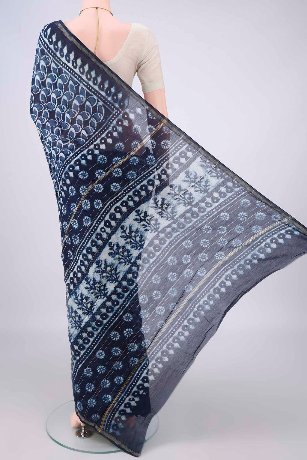 Flat view of Navy Blue Chanderi Cotton Saree with Batik Print on the body and Thin Zari Line. 