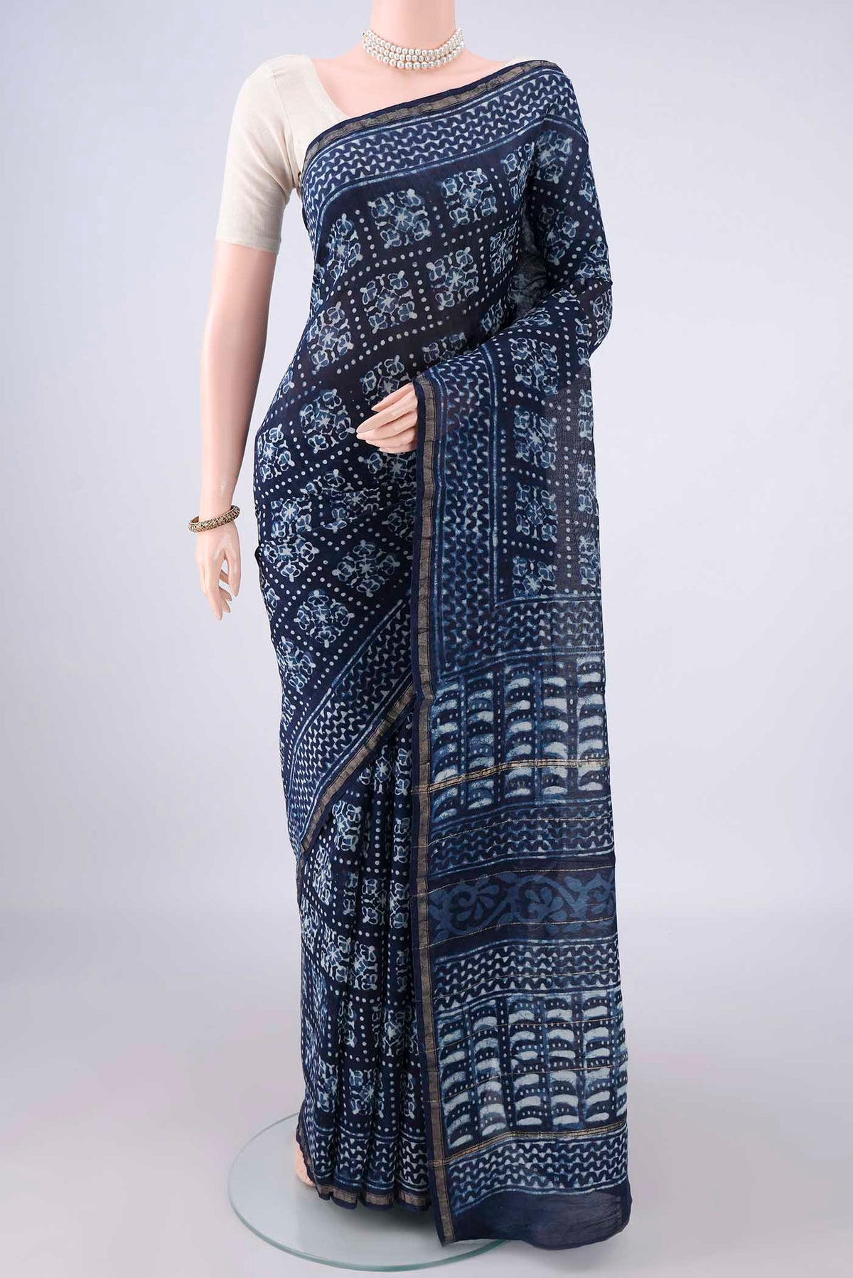 Indigo Chanderi Cotton Saree with Batik Print on the body and Thin Zari Line.  displayed on a mannequin