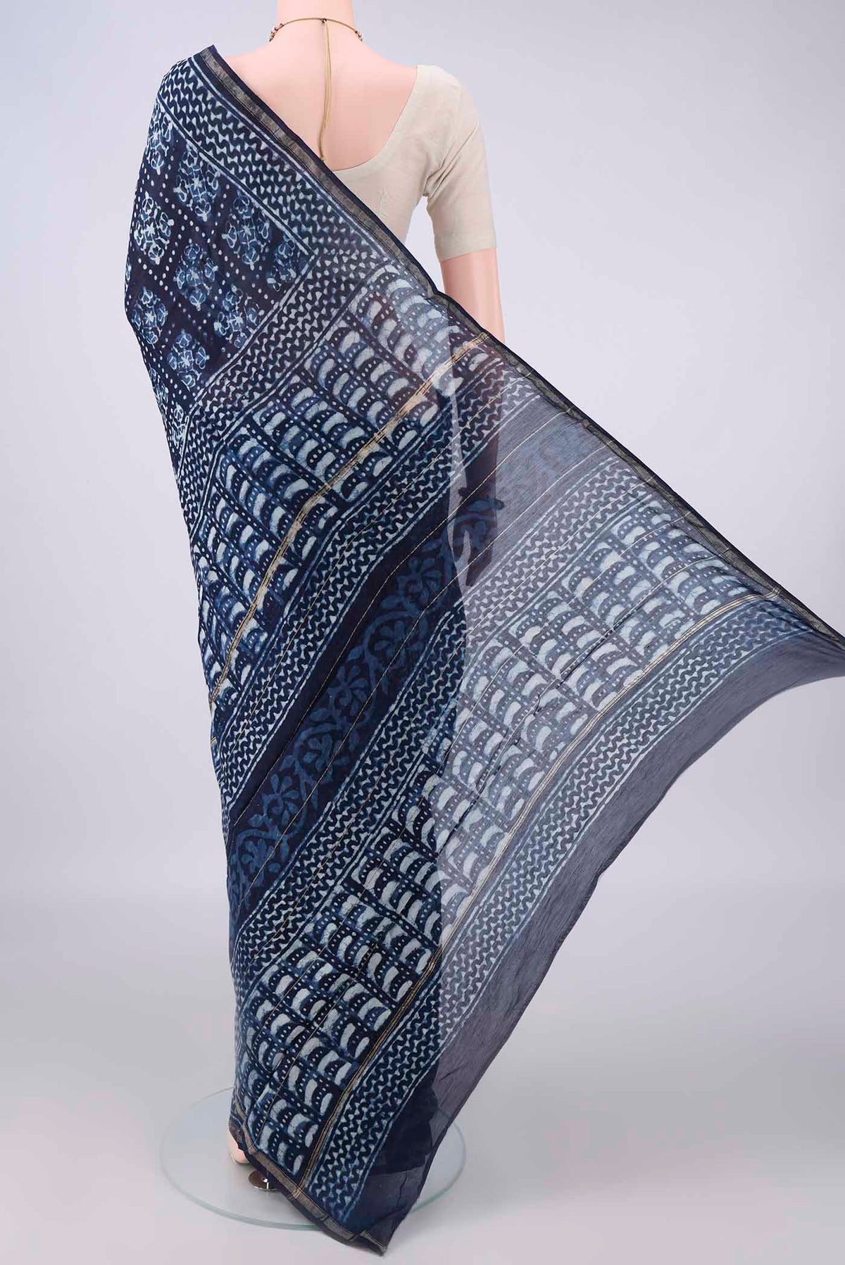 Flat view of Indigo Chanderi Cotton Saree with Batik Print on the body and Thin Zari Line. 