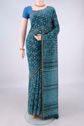 Teal Chanderi Cotton Saree with Batik Print on the body and Thin Zari Line.  displayed on a mannequin