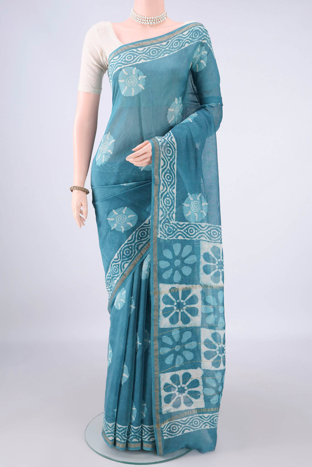 Maya Blue Chanderi Cotton Saree with Batik Print on the body and Thin Zari Line.  displayed on a mannequin