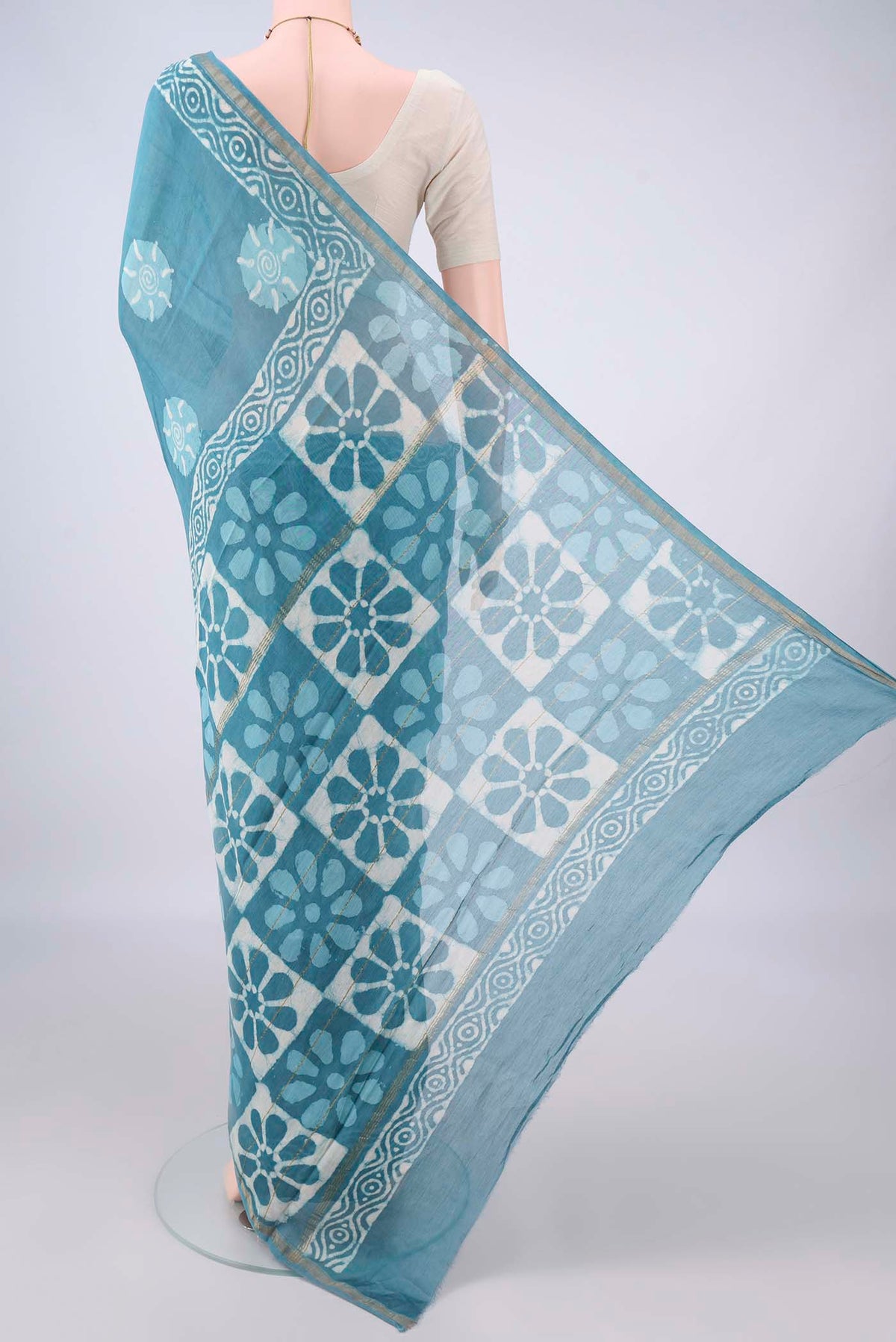 Flat view of Maya Blue Chanderi Cotton Saree with Batik Print on the body and Thin Zari Line. 
