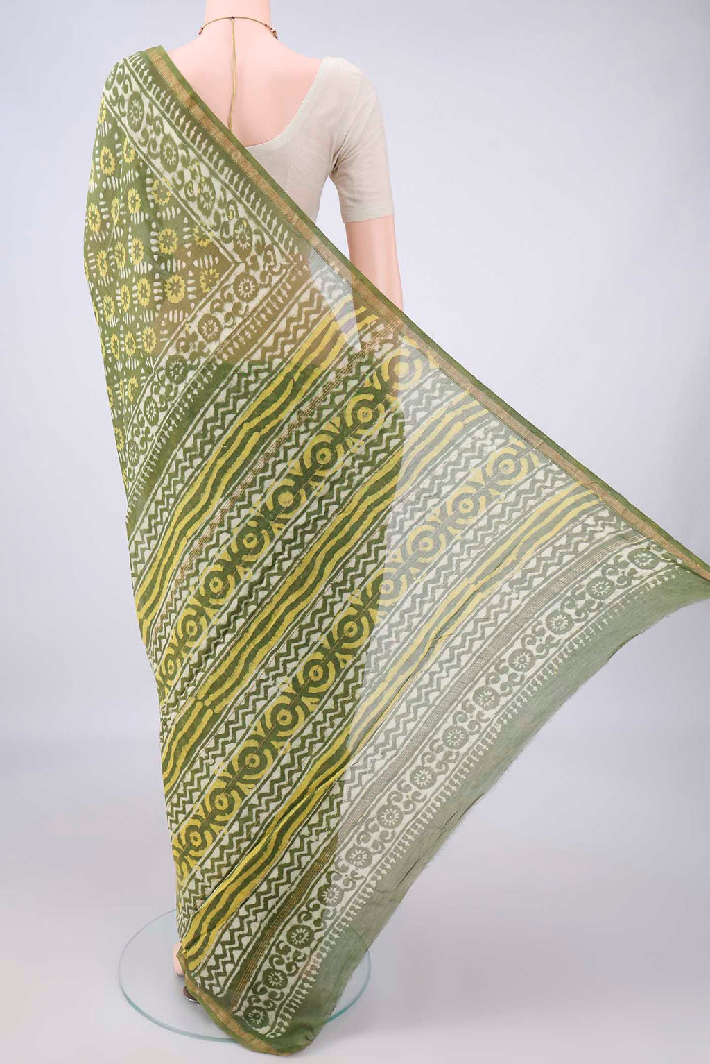 Flat view of Olive Green Chanderi Cotton Saree with Batik Print on the body and Thin Zari Line. 