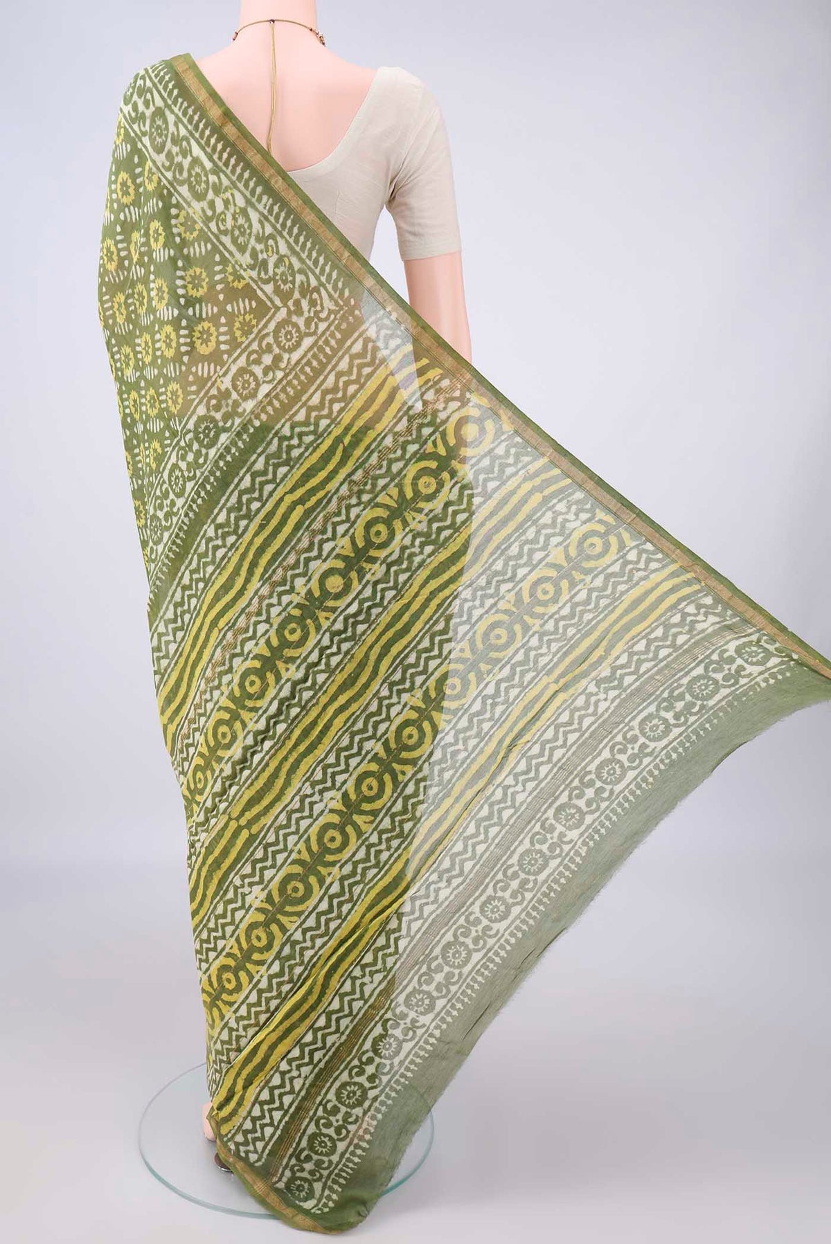 Flat view of Olive Green Chanderi Cotton Saree with Batik Print on the body and Thin Zari Line. 