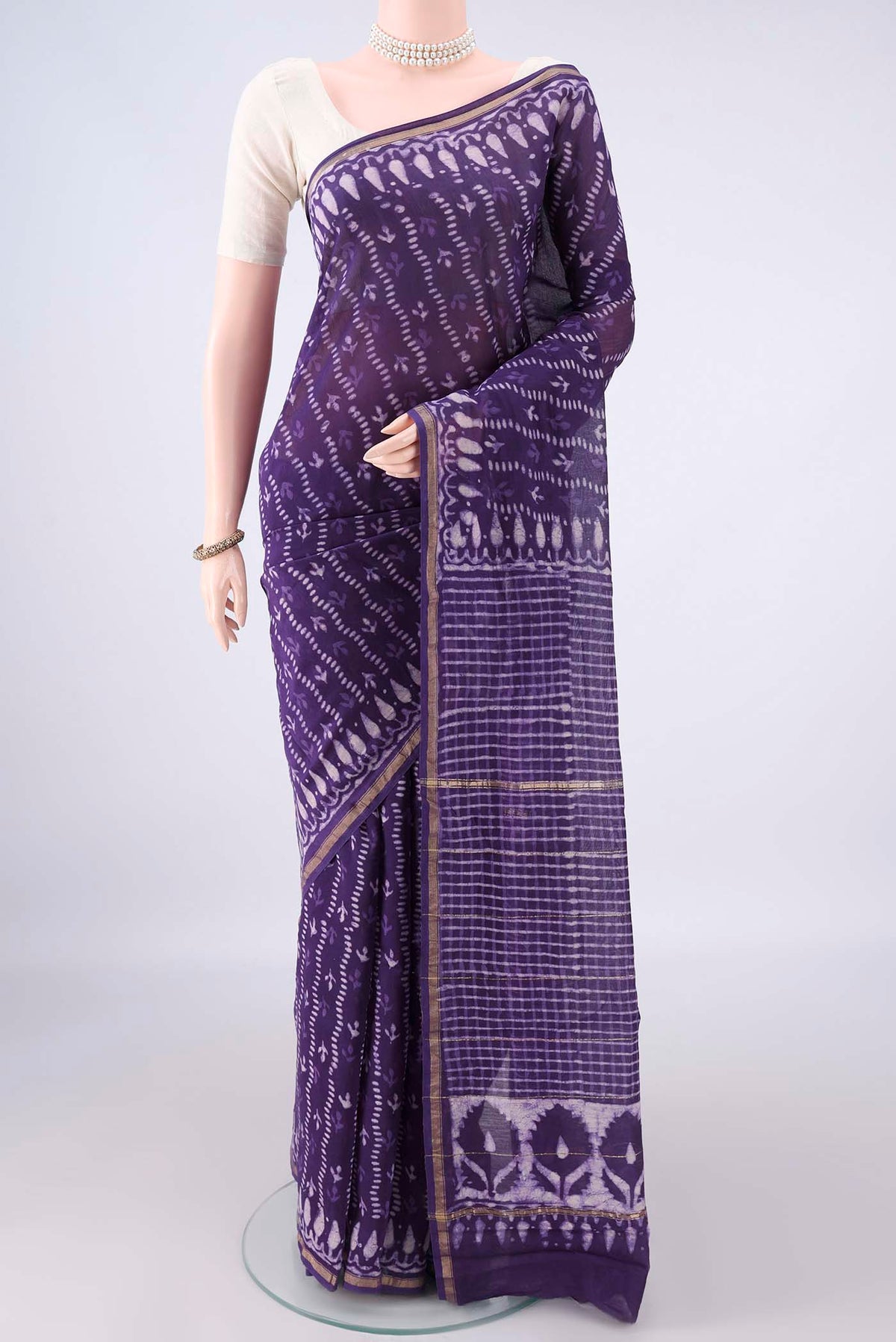 Purple Chanderi Cotton Saree with Batik Print on the body and Thin Zari Line.  displayed on a mannequin