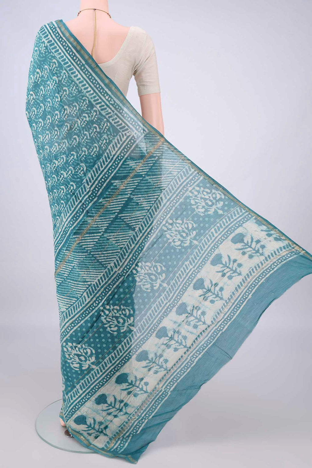 Flat view of Maya Blue Chanderi Cotton Saree with Batik Print on the body and Thin Zari Line. 