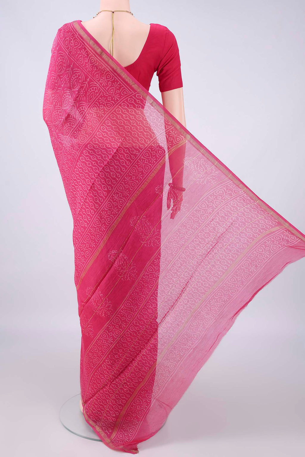 Flat view of Pink Chanderi Cotton Saree with Batik Print on the body and Thin Zari Line. 
