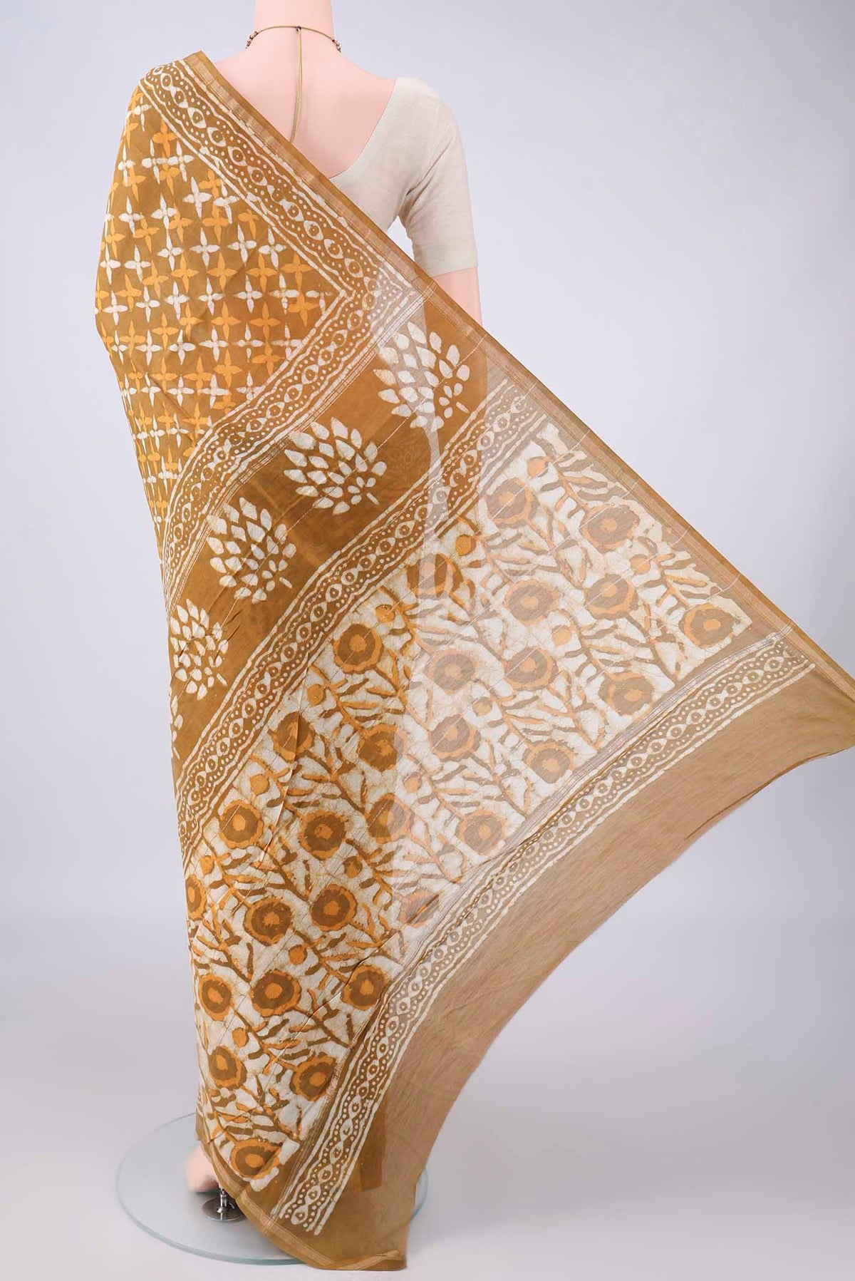 Flat view of Mustard Chanderi Cotton Saree with Batik Print on the body and Thin Zari Line. 