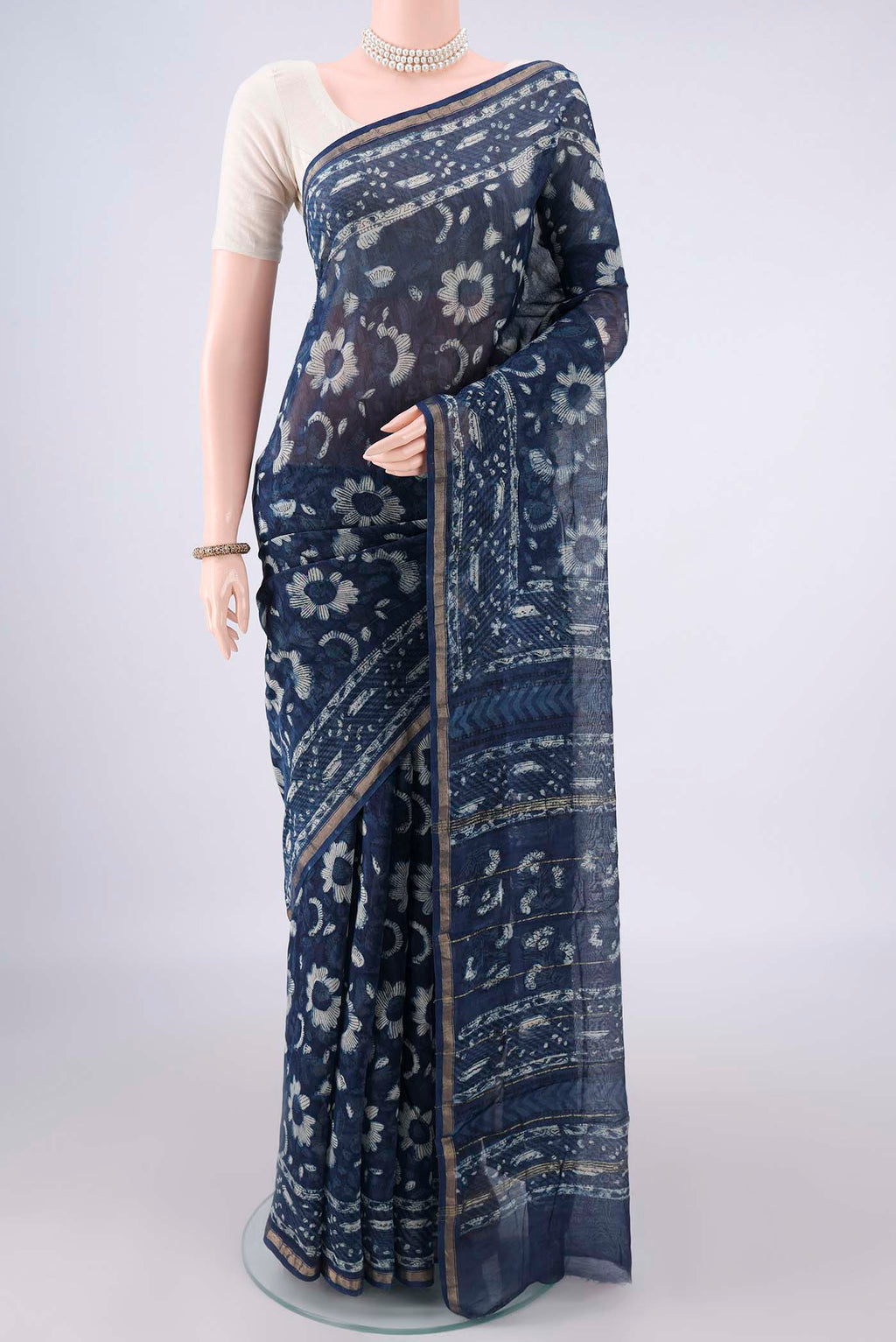 Indigo Chanderi Cotton Saree with Batik Print on the body and Thin Zari Line.  displayed on a mannequin