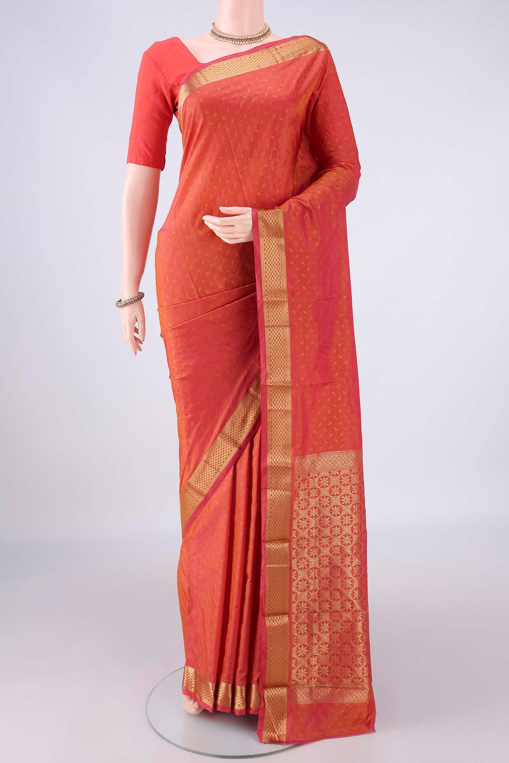 Brick Orange Blended Bangalore Silk Saree with Jacquard design on the body and Zari Border.  displayed on a mannequin
