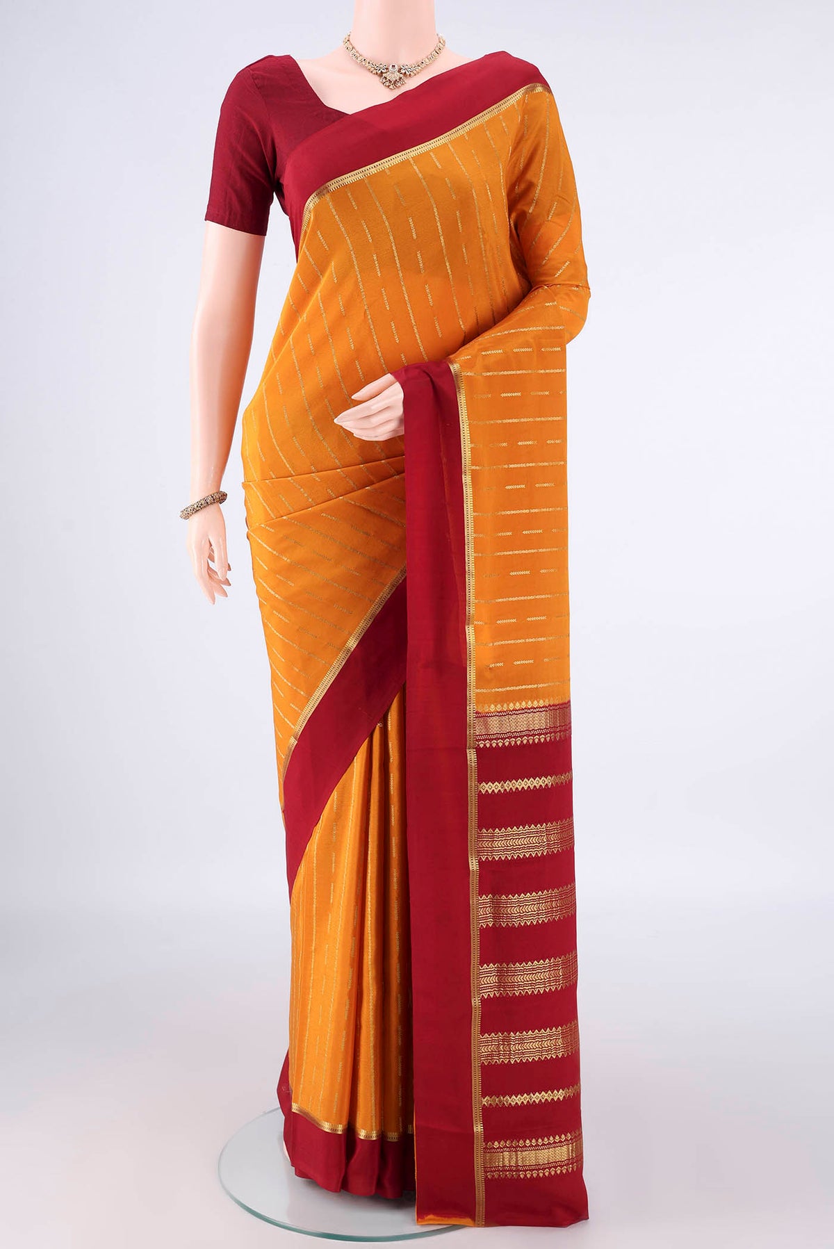 Mustard Mysore Crepe Saree with Stripes on the body and Plain Border.  displayed on a mannequin