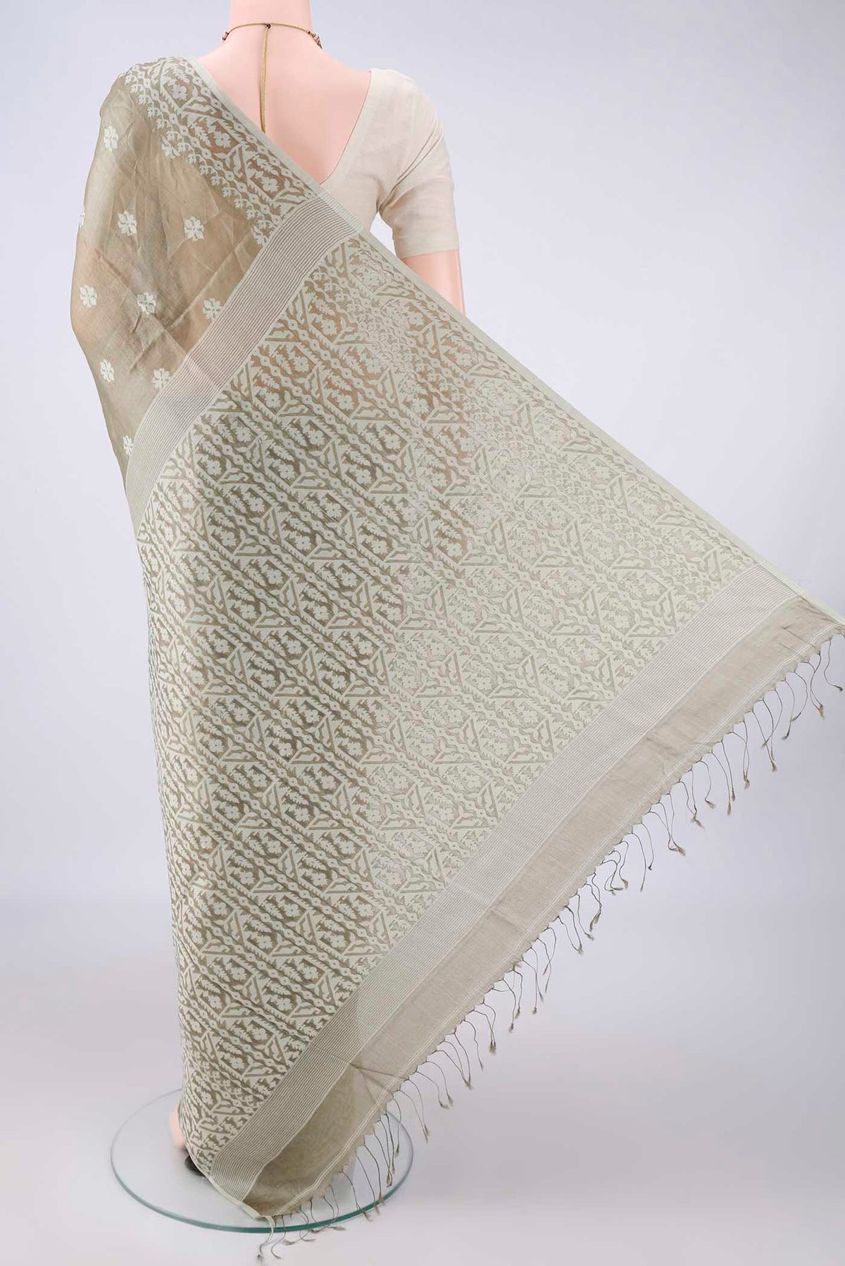 Flat view of Sage Green Tussar Saree with Jamdani on the body and Thread Border. 