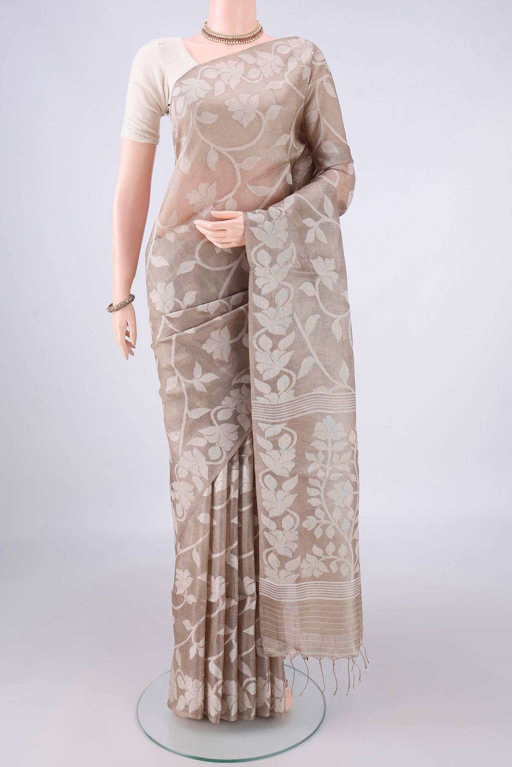 Beige Tussar Saree with Thread Brocade on the body and Thread Border.  displayed on a mannequin