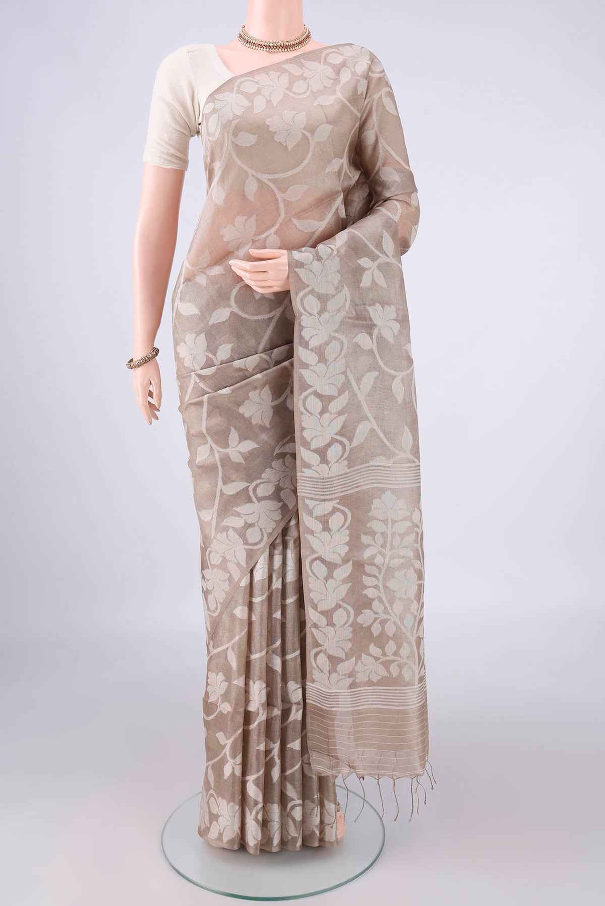 Beige Tussar Saree with Thread Brocade on the body and Thread Border.  displayed on a mannequin