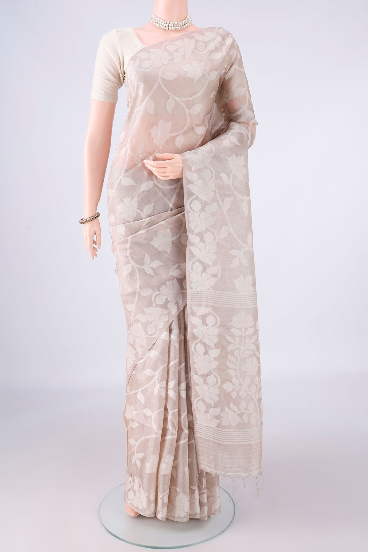 Beige Tussar Saree with Jamdani on the body and Thread Border.  displayed on a mannequin