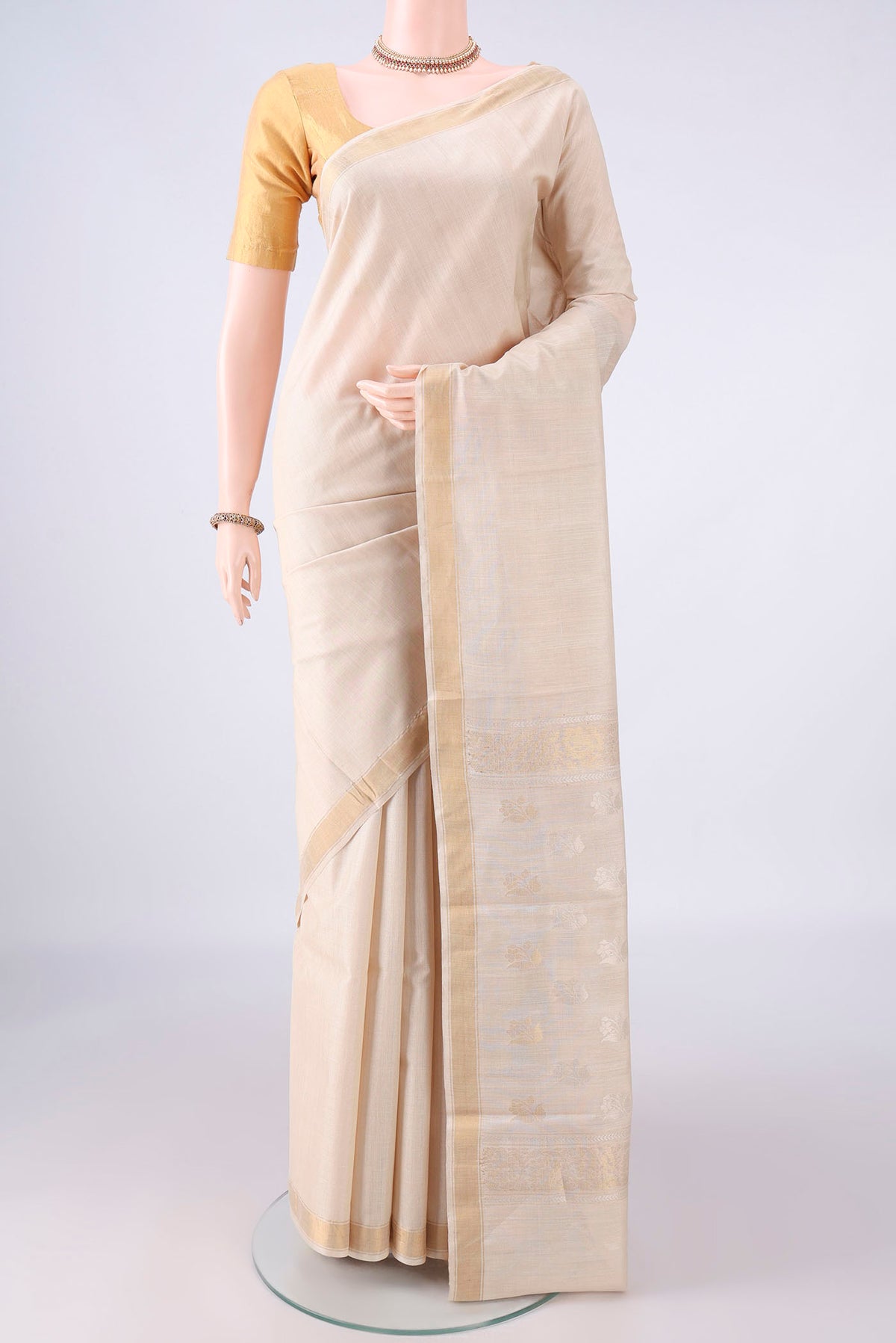 Beige Tussar Saree with Plain Body and Zari Border.  displayed on a mannequin