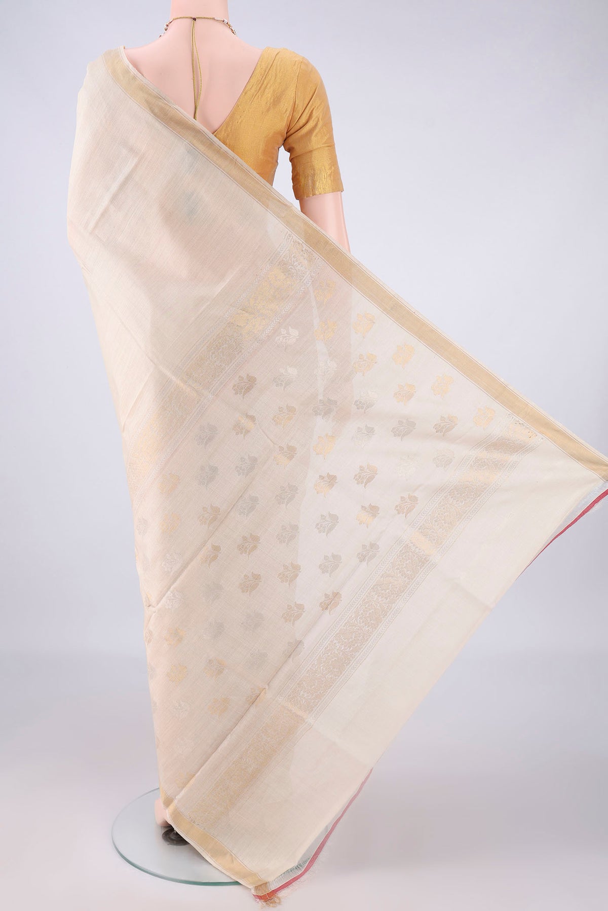 Flat view of Beige Tussar Saree with Plain Body and Zari Border. 