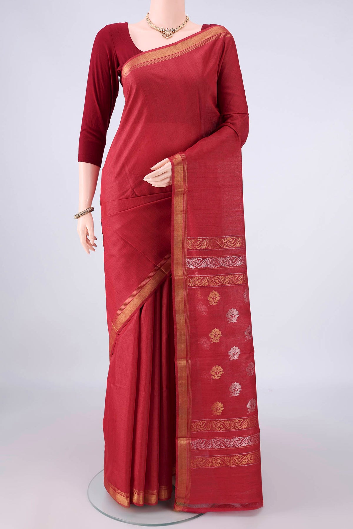 Red Tussar Saree with Plain Body and Zari Border.  displayed on a mannequin