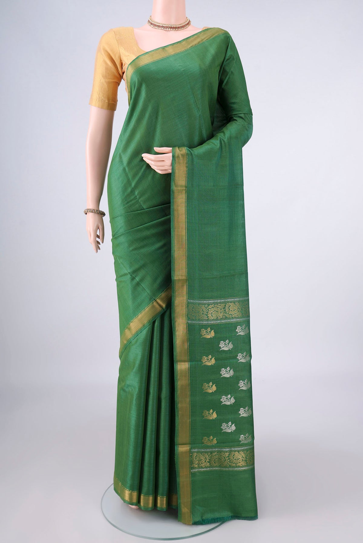 Green Tussar Saree with Plain Body and Zari Border.  displayed on a mannequin