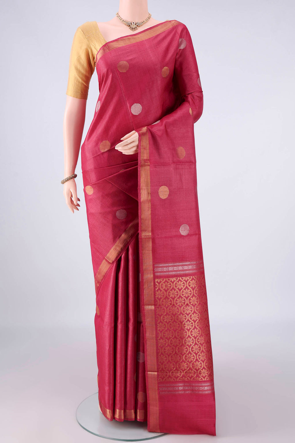 Coral MP Tussar Saree with Zari Butta on the body and Zari Border.  displayed on a mannequin
