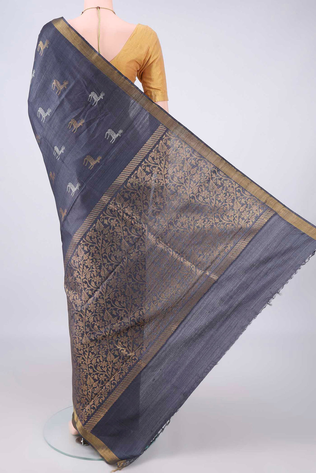Flat view of Grey MP Tussar Saree with Zari Butta on the body and Zari Border. 