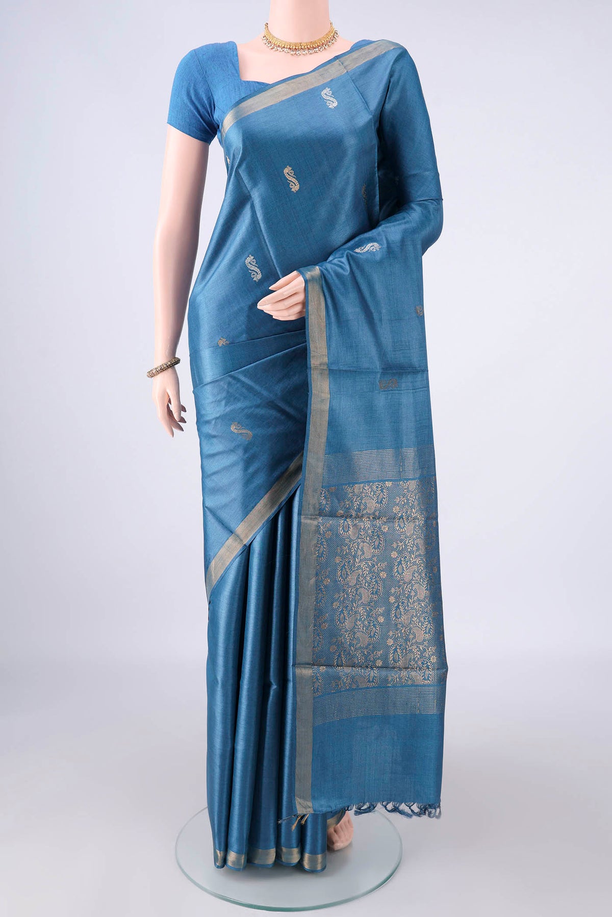 Maya Blue Tussar Saree with Zari Butta on the body and Zari Border.  displayed on a mannequin