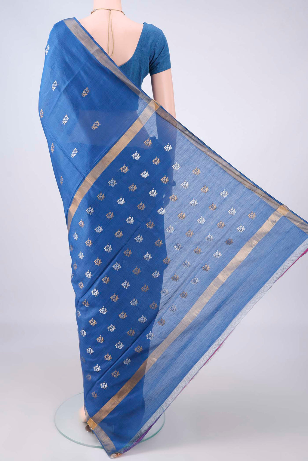 Flat view of Blue Tussar Saree with Zari Butta on the body and Zari Border. 