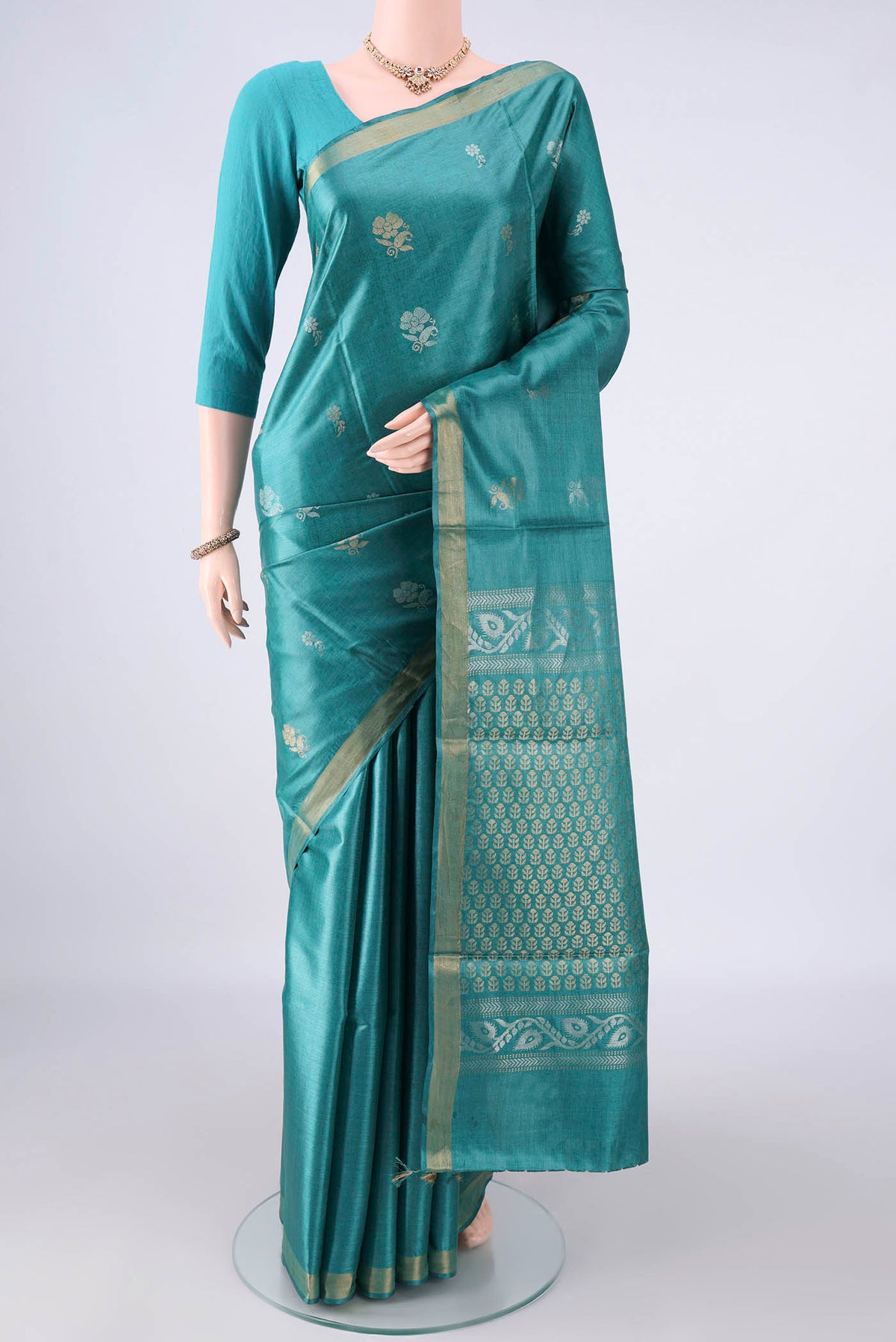 Sea Green MP Tussar Saree with Zari Butta on the body and Zari Border.  displayed on a mannequin