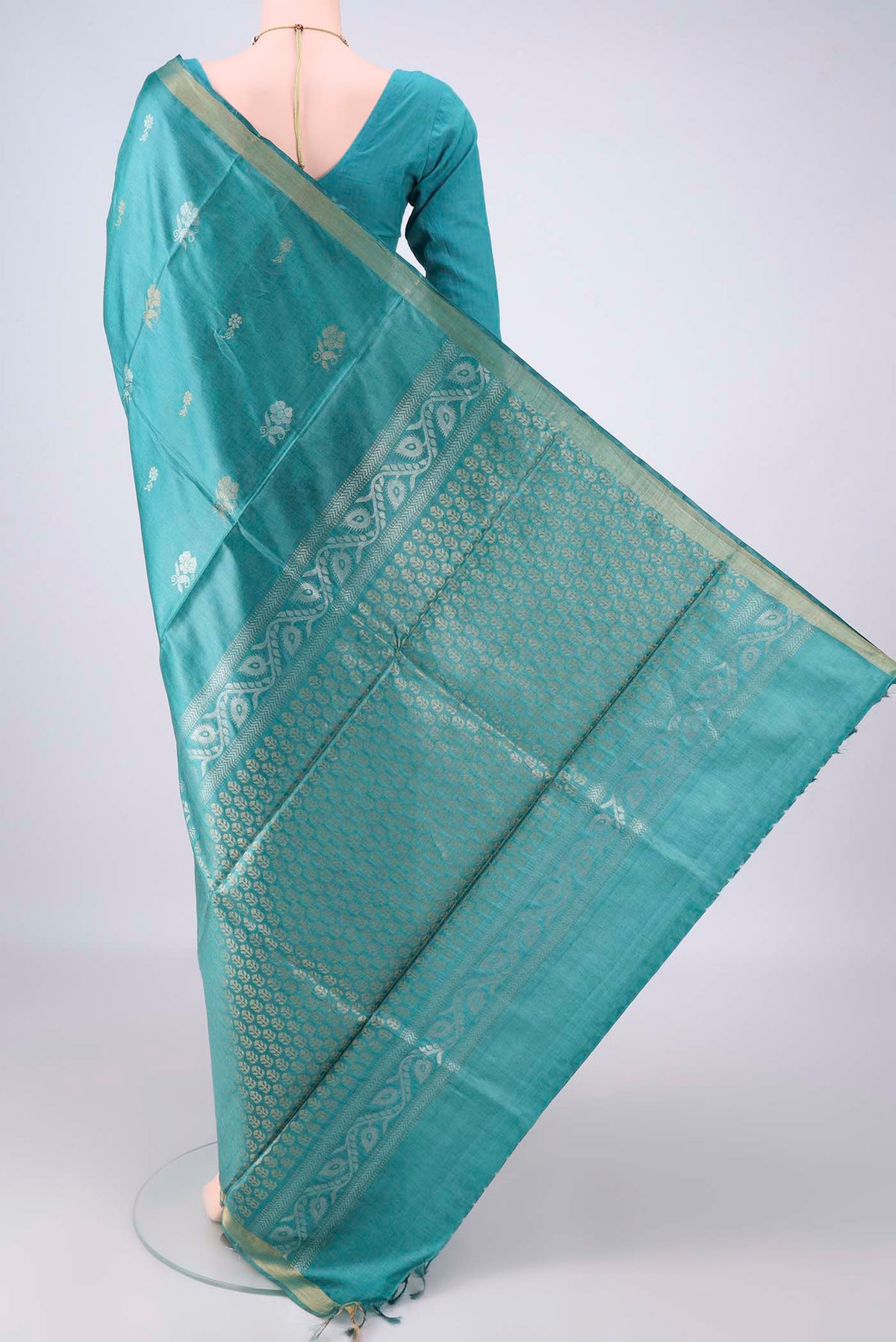 Flat view of Sea Green MP Tussar Saree with Zari Butta on the body and Zari Border. 