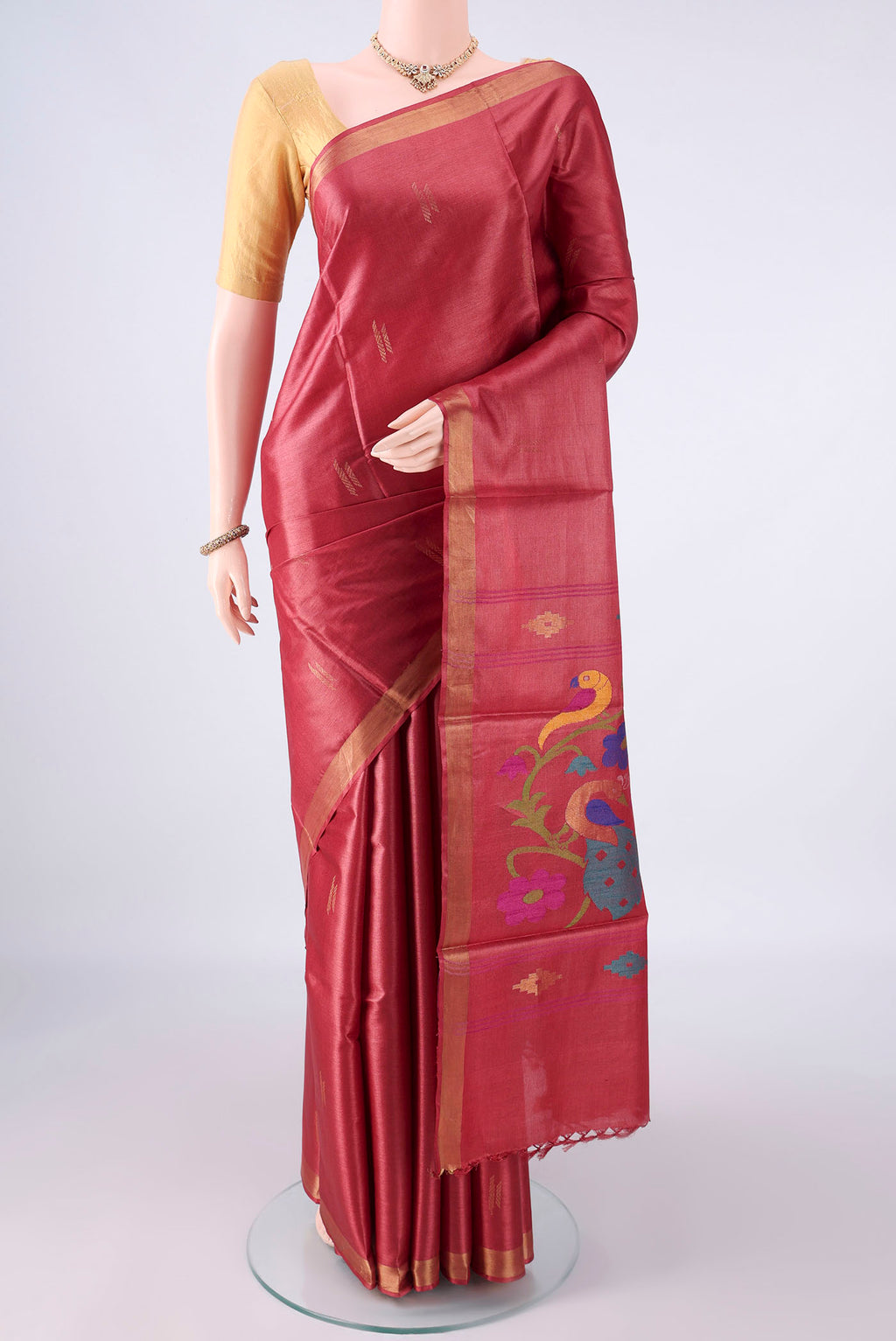 Rust MP Tussar Saree with Zari Butta on the body and Zari Border.  displayed on a mannequin