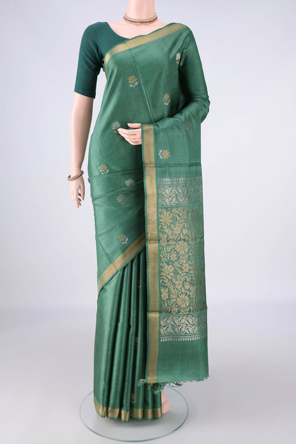 Green MP Tussar Saree with Zari Butta on the body and Zari Border.  displayed on a mannequin