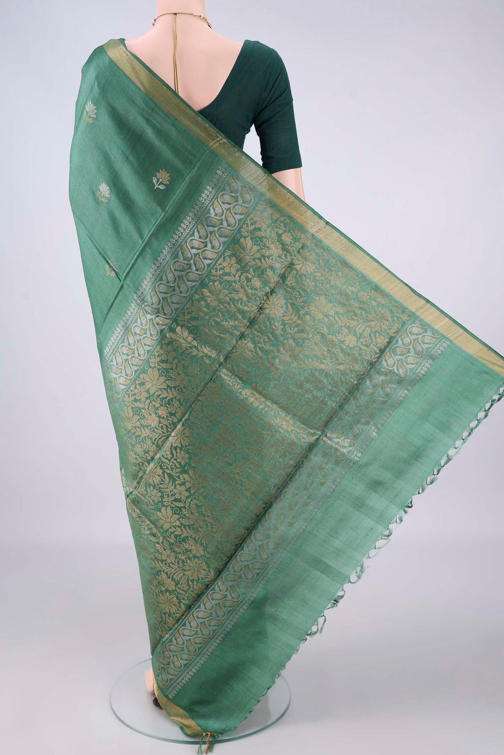 Flat view of Green MP Tussar Saree with Zari Butta on the body and Zari Border. 