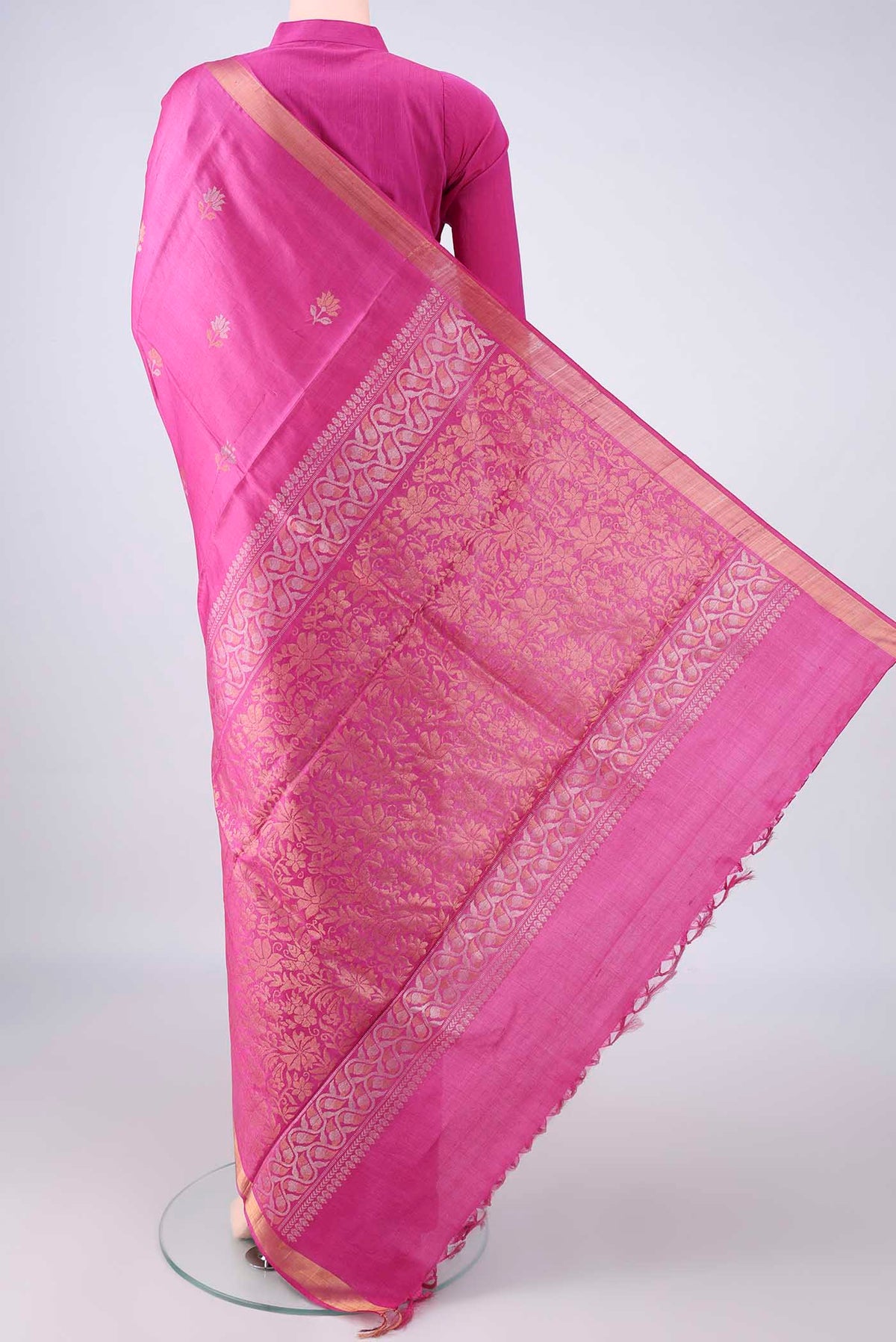 Flat view of Rani Pink Tussar Saree with Zari Butta on the body and Zari Border. 