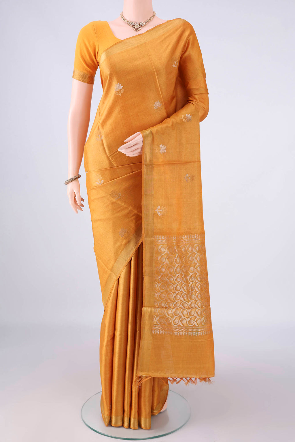 Mustard MP Tussar Saree with Zari Butta on the body and Zari Border.  displayed on a mannequin