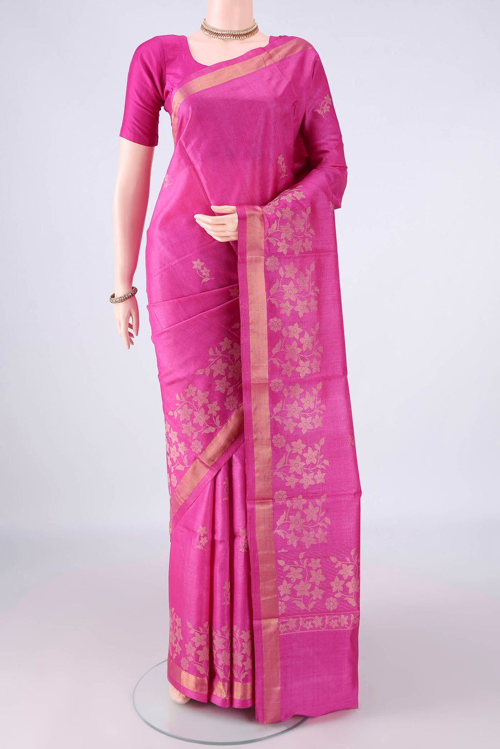 Rani Pink MP Tussar Saree with Zari Butta on the body and Zari Border.  displayed on a mannequin