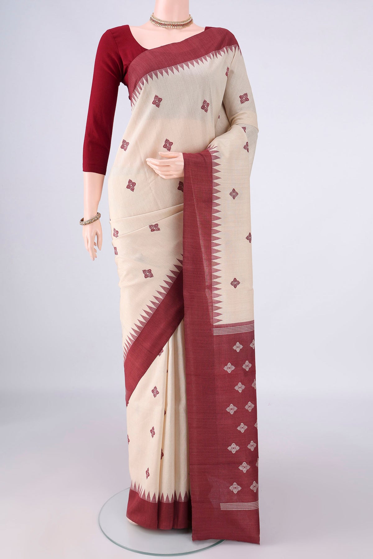 Beige Tussar Saree with Thread Butta on the body and Plain Border.  displayed on a mannequin