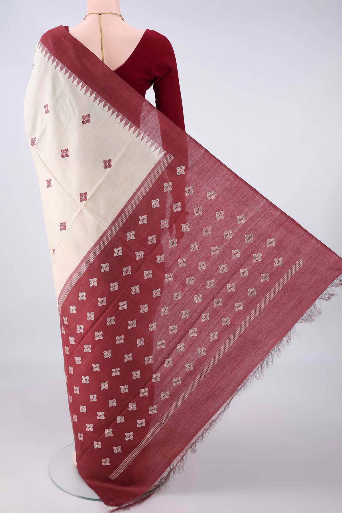 Flat view of Beige Tussar Saree with Thread Butta on the body and Plain Border. 