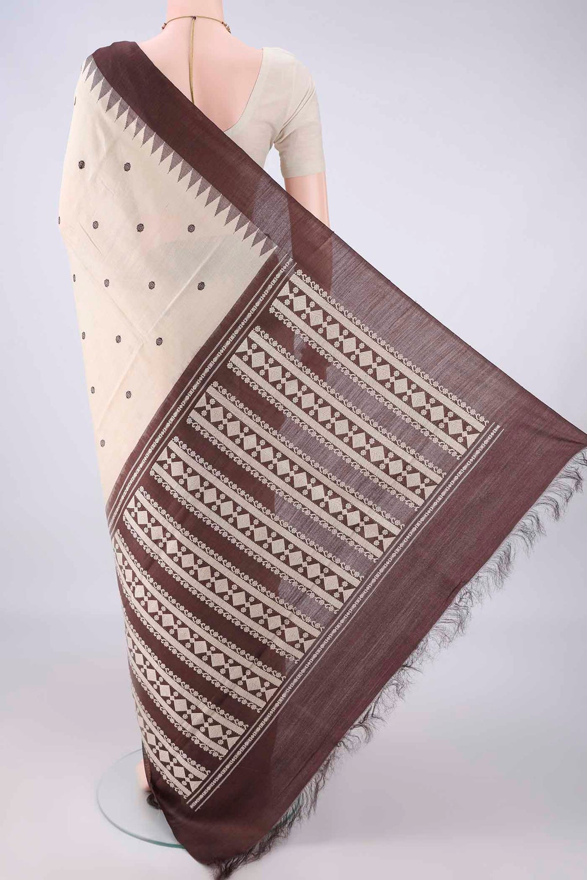 Flat view of Beige MP Tussar Saree with Thread Butta on the body and Plain Border. 