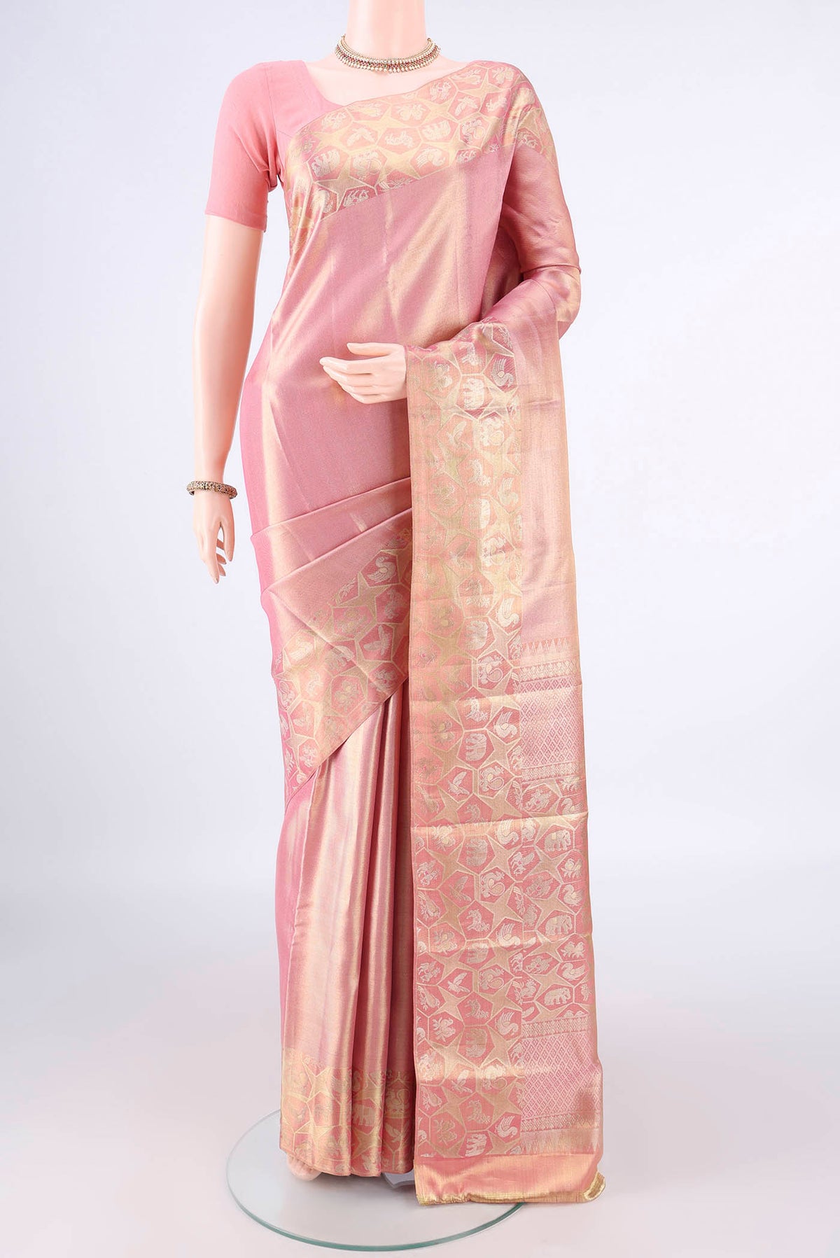 Golden Peach Dual Tone Kanjivaram Tissue Saree with Zari Brocade on the body and Zari Border.  displayed on a mannequin
