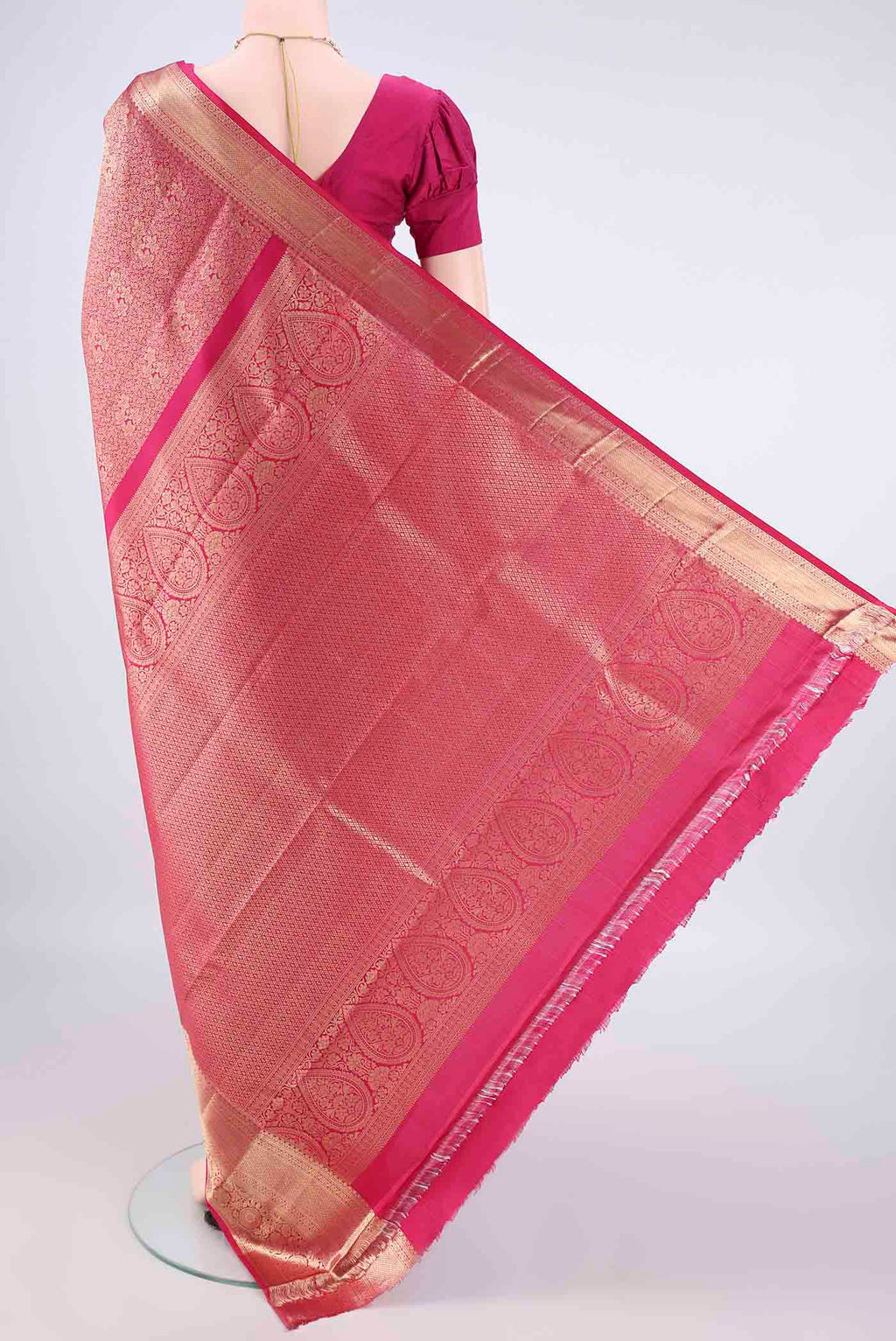 Flat view of Pure Silk Rani Pink Kanchipuram Saree with Zari Brocade on the body and Zari Border. 