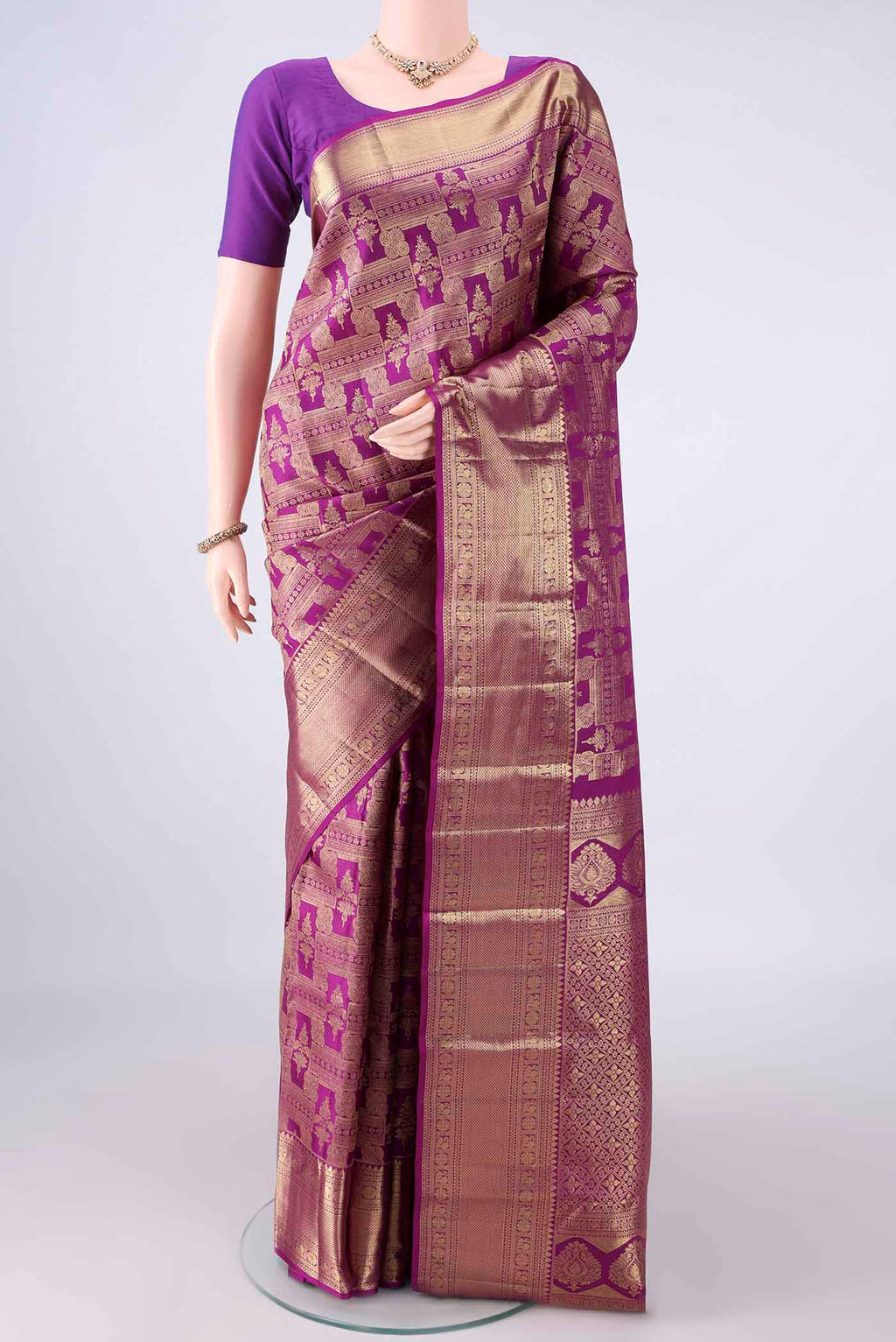 Pure Silk Magenta Kanchipuram Saree with Zari Brocade on the body and Zari Border.  displayed on a mannequin