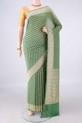 Green Banarasi Georgette Saree with Zari Butta on the body and Zari Border.  displayed on a mannequin
