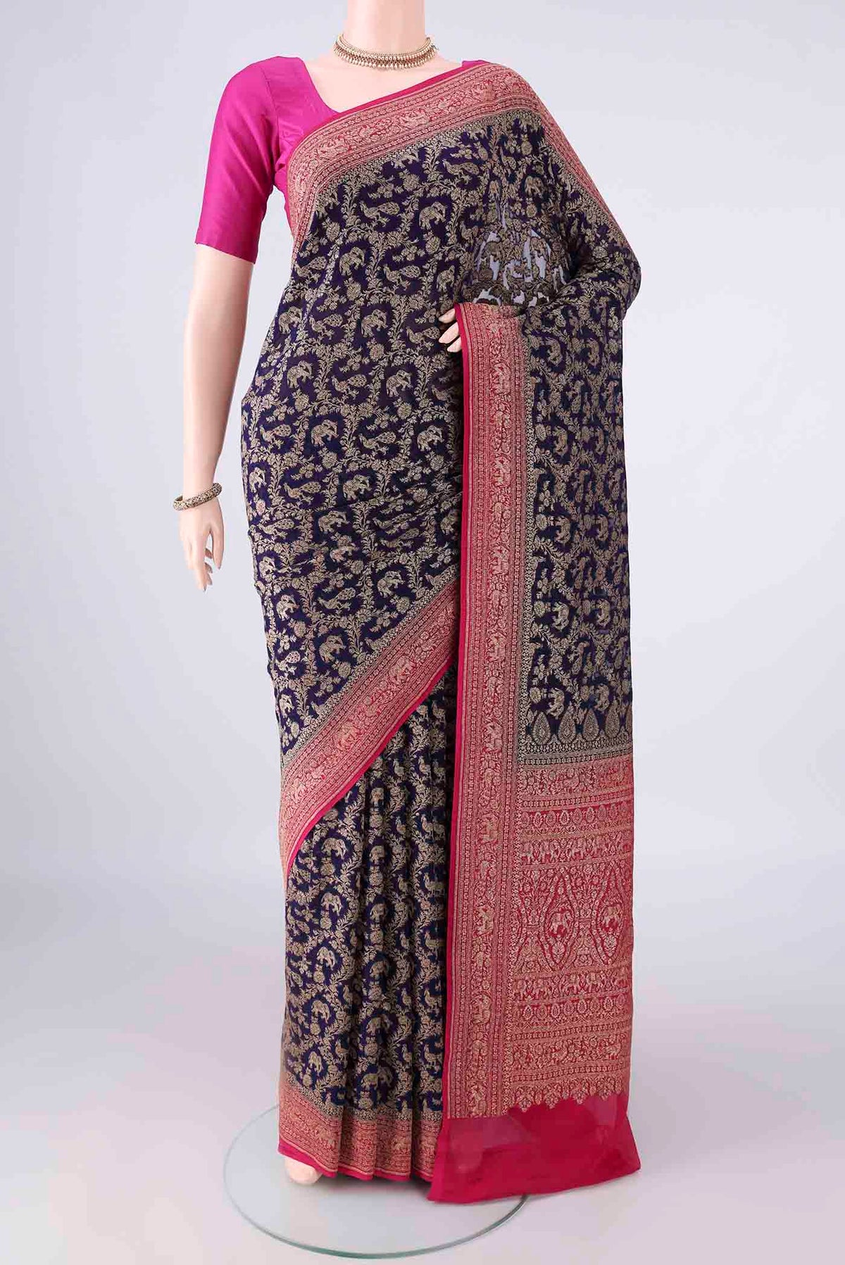 Navy Blue Banarasi Georgette Saree with Zari Butta on the body and Zari Border.  displayed on a mannequin